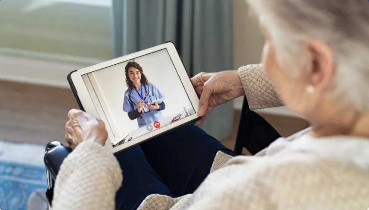 Elderly person on video call with doctor