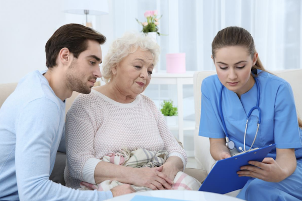 Healthcare team meeting with elderly patient and family